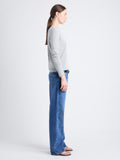 Side full length image of model wearing Tina Sweater In Cotton Silk in LIGHT GREY MELANGE