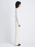Side image of model in Tina Sweater In Cotton Silk in white