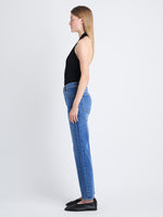 Side full length image of model wearing Jasper Jean in MEDIUIM BLUE