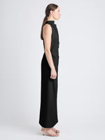 Side image of model wearing Selena Twist Back Dress in Matte Viscose Crepe in black