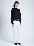 Side full length image of model wearing Brooks Polo in Cotton Terry Jersey in BLACK