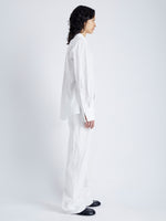 Side full length image of model wearing Allen Shirt in Crinkled Cotton Gabardine in WHITE