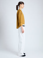 Side full length image of model wearing Olson T-Shirt in Eco Cotton Jersey in CIDER