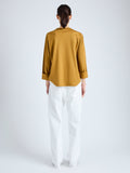 Back full length image of model wearing Olson T-Shirt in Eco Cotton Jersey in CIDER