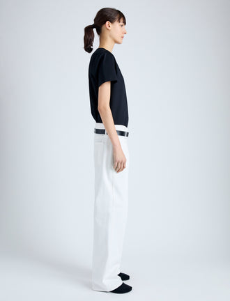 Side full length image of model wearing Kira T-Shirt in Eco Cotton Jersey in BLACK