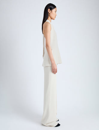 Side full length image of model wearing Weyes Pant In Light Matte Viscose Crepe in WHEAT