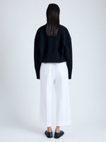 Back full length image of model wearing Amara Pant in Organic Cotton Twill Suiting in OFF WHITE