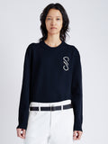 Cropped front  image of model wearing Harrison Monogram Sweater in Wool Jacquard in navy