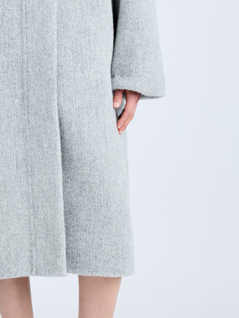 Proenza Schouler Detail image of model wearing Albers Coat in Textured Double Face Wool in LIGHT GREY MULTI