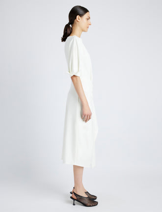 Proenza Schouler Side full length image of model wearing Maisie Dress in Matte Viscose Crepe in IVORY