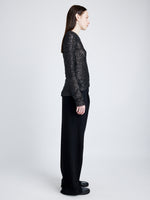 Proenza Schouler Side full length image of model wearing Sophie Long Sleeve Top in Sequin in BLACK