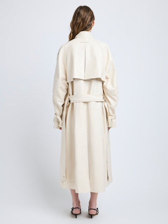 Proenza Schouler Back full length image of model wearing Sabina Coat in Lacquered Leather in Ecru