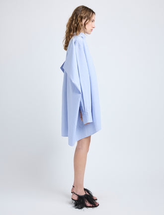 Proenza Schouler Side full length image of model wearing Isla Dress in Stripe Cotton Silk Poplin in Pale Blue Multi