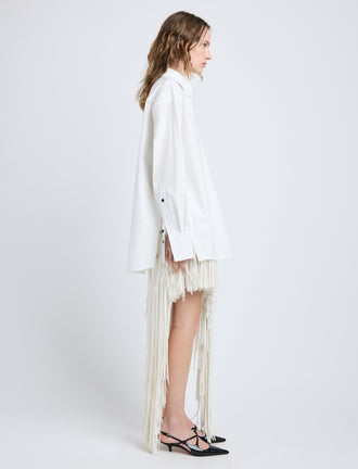 Proenza Schouler Side full length image of model wearing Phia Skirt in Leather Silk Fringe in Ecru