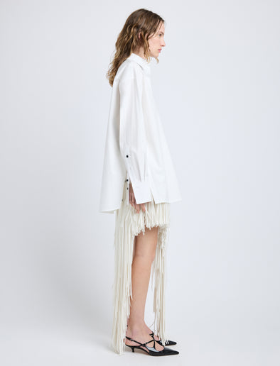 Proenza Schouler Side full length image of model wearing Phia Skirt in Leather Silk Fringe in Ecru