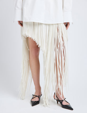 Proenza Schouler Detail image of model wearing Phia Skirt in Leather Silk Fringe in Ecru