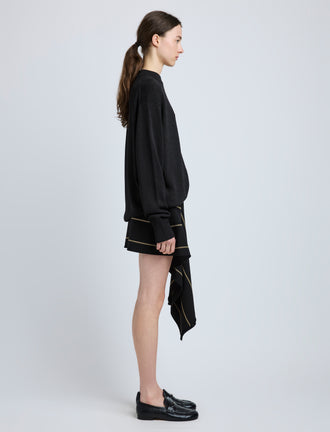 Proenza Schouler Side full length image of model wearing Rae Skirt in Stripe Bi-Stretch Viscose in Black Multi