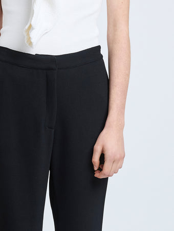 Proenza Schouler Detail image of model wearing Alexia Pant in Bi-Stretch Suiting in Black