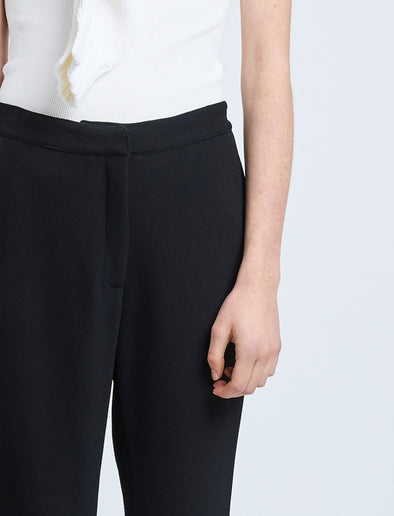 Proenza Schouler Detail image of model wearing Alexia Pant in Bi-Stretch Suiting in Black