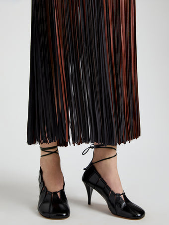 Proenza Schouler Detail image of model wearing Veda Skirt in Faux Leather Fringe in Brown Multi