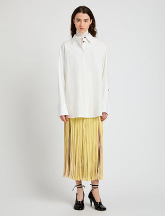 Proenza Schouler Front full length image of model wearing Veda Skirt in Faux Leather Fringe in Pale Yellow Multi