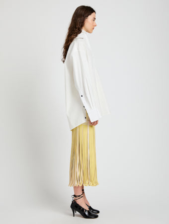 Proenza Schouler Side full length image of model wearing Veda Skirt in Faux Leather Fringe in Pale Yellow Multi