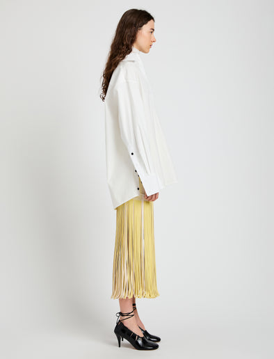 Proenza Schouler Side full length image of model wearing Veda Skirt in Faux Leather Fringe in Pale Yellow Multi
