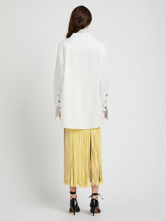 Proenza Schouler Back full length image of model wearing Veda Skirt in Faux Leather Fringe in Pale Yellow Multi