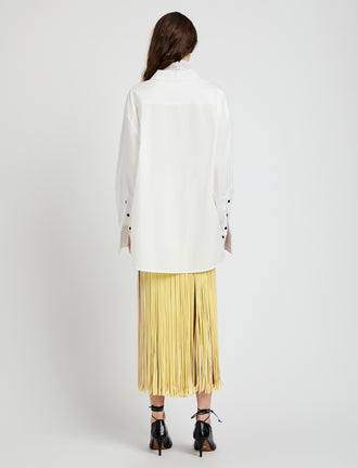 Proenza Schouler Back full length image of model wearing Veda Skirt in Faux Leather Fringe in Pale Yellow Multi