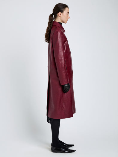 Proenza Schouler Side full length image of model wearing Nissi Coat In Semigloss Leather in Burgundy