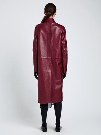 Proenza Schouler Back full length image of model wearing Nissi Coat In Semigloss Leather in Burgundy