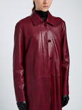 Proenza Schouler Detail image of model wearing Nissi Coat In Semigloss Leather in Burgundy