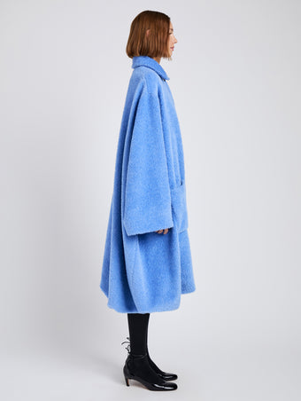 Proenza Schouler Side full length image of model wearing Verretta Coat In Alpaca Coating in Sky Blue