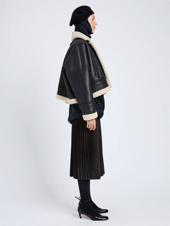 Proenza Schouler Side full length image of model wearing Alya Jacket In Shearling in Black, white
