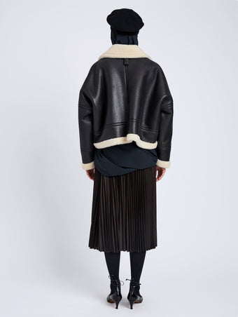 Proenza Schouler Back full length image of model wearing Alya Jacket In Shearling in Black, white