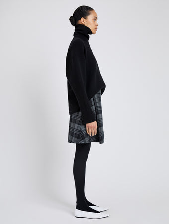 Proenza Schouler Side full length image of model wearing Cassia Skirt In Plaid Wool Suiting in Grey Multi