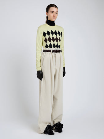 Proenza Schouler Side full length image of model wearing Vivian Top In Argyle Knit in Yellow Multi