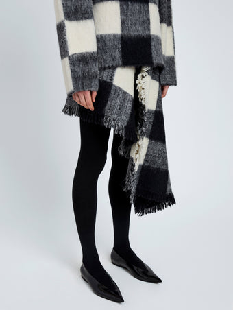 Proenza Schouler Detail image of model wearing Kai Skirt In Brushed Glenplaid Knit in Black Multi