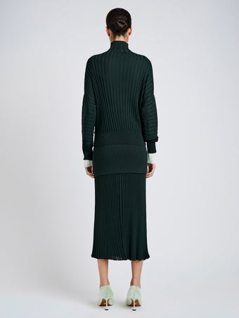 Proenza Schouler Back full length image of model wearing Luiza Skirt in Sunburst Rib in Bottle Green