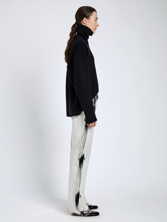 Proenza Schouler Side full length image of model wearing Ryman Jean in Fade Out Black in Black Denim