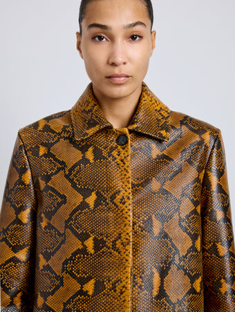 Proenza Schouler Detail image of model wearing Leticia Coat in Python Print in Gold Multi
