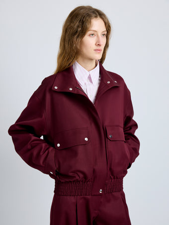 Proenza Schouler Detail image of model wearing Aviva Jacket in Wool Gabardine in Oxblood