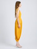 Proenza Schouler Side full length image of model wearing Sukki Dress in Draped Viscose in Marigold