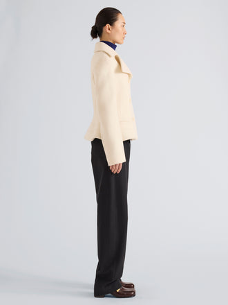 Proenza Schouler Side full length image of model wearing Romane Jacket in Compact Melton Wool in Ivory