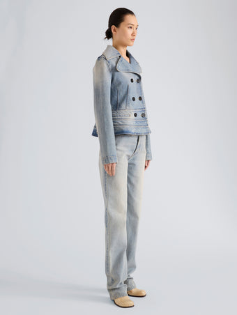 Proenza Schouler Side full length image of model wearing Romane Jacket in Rigid Denim in Light Vintage Blue Wash