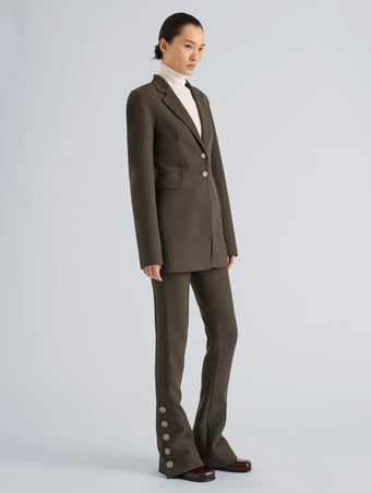 Proenza Schouler Side full length image of model wearing Maera Jacket in Bi-Stretch Double Wool in Earth