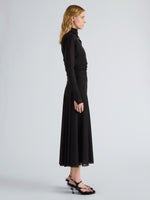 Proenza Schouler Side full length image of model wearing Golda Dress in Textured Sheer Jersey in Black