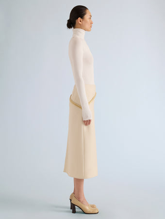 Proenza Schouler Side full length image of model wearing Justine Skirt in Bonded Wool Satin in Off White Tahini