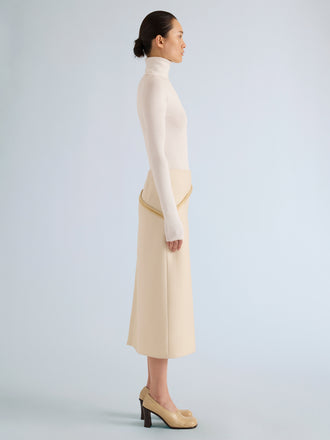 Proenza Schouler Side full length image of model wearing Justine Skirt in Bonded Wool Satin in Off White Tahini