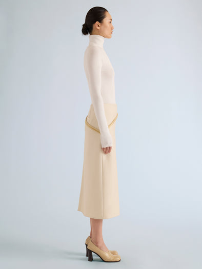 Proenza Schouler Side full length image of model wearing Justine Skirt in Bonded Wool Satin in Off White Tahini